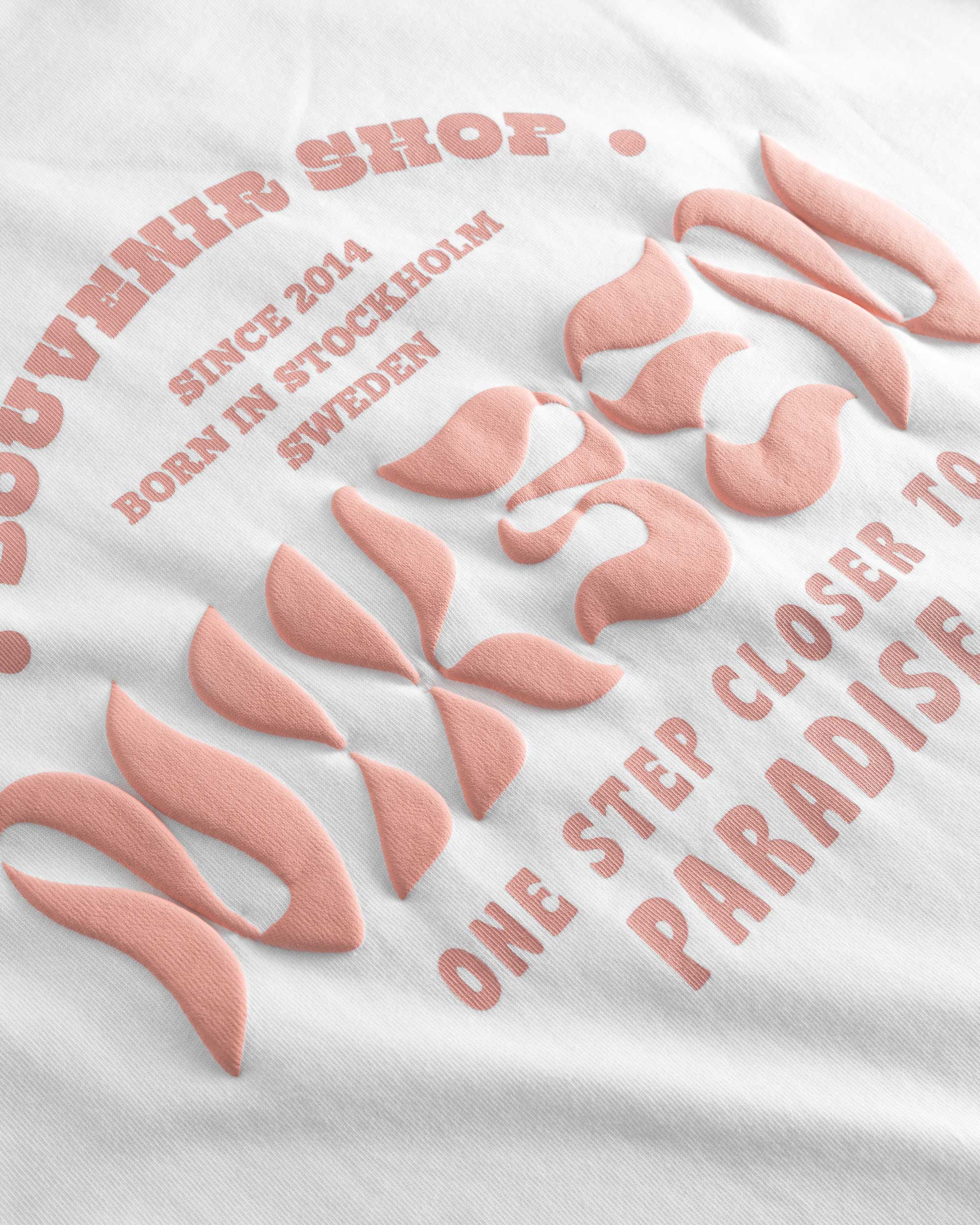 Close up view of orange text print on white t-shirt.