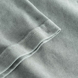 Close-up view of the sleeve and stitchings on a grey t-shirt