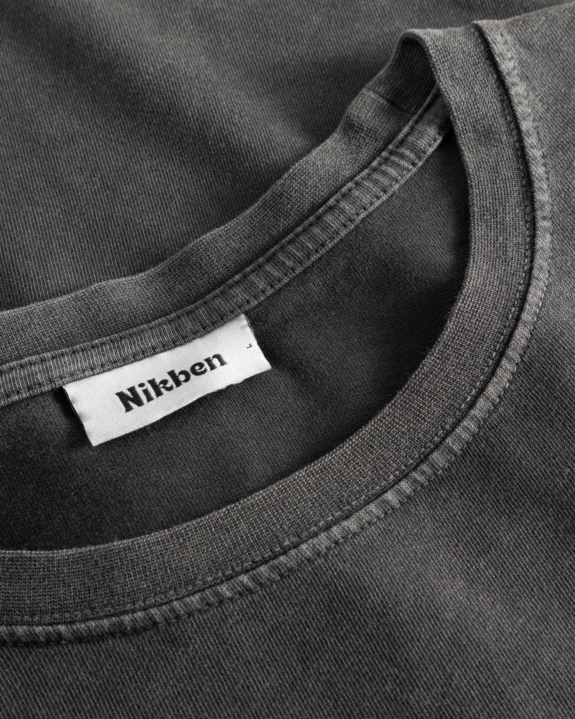 Close-up of round neck and stitching on washed black T-shirt