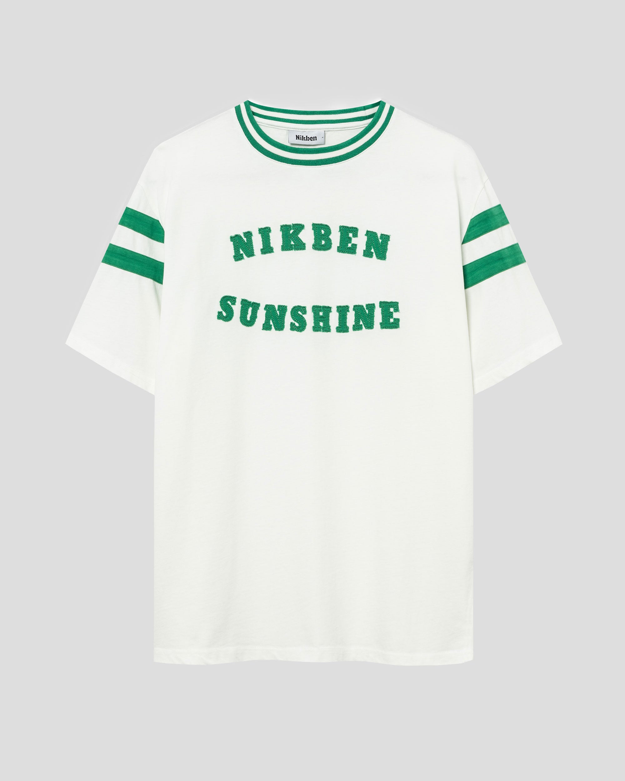White t-shirt with green "Sunshine" print on the chest.