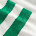Close-up of  stitching on white/green T-shirt