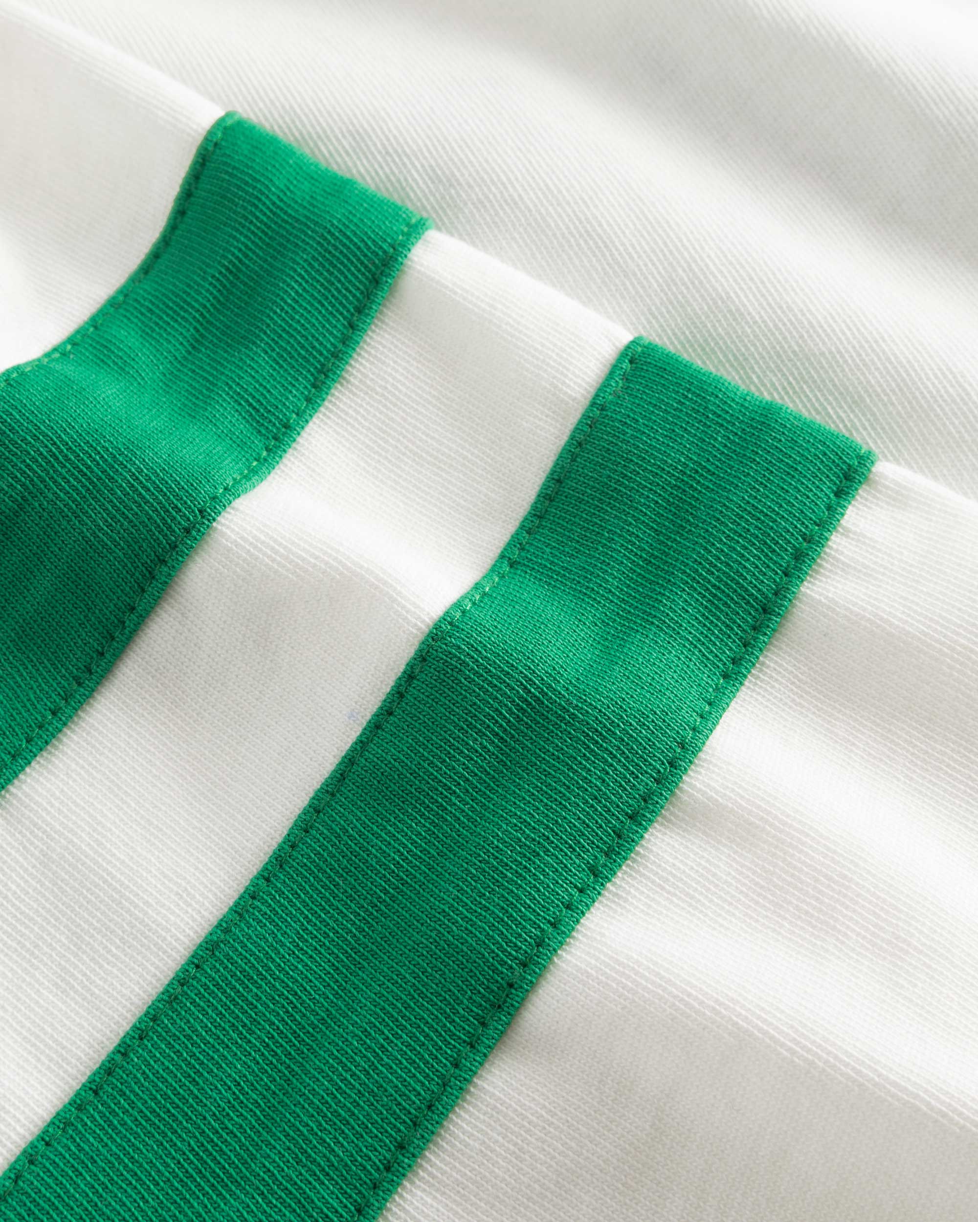 Close-up of  stitching on white/green T-shirt