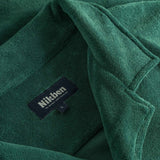 Close up of open collar and tag on a green short sleeve shirt