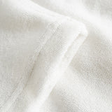 Close up of leg on off white terry toweling pants