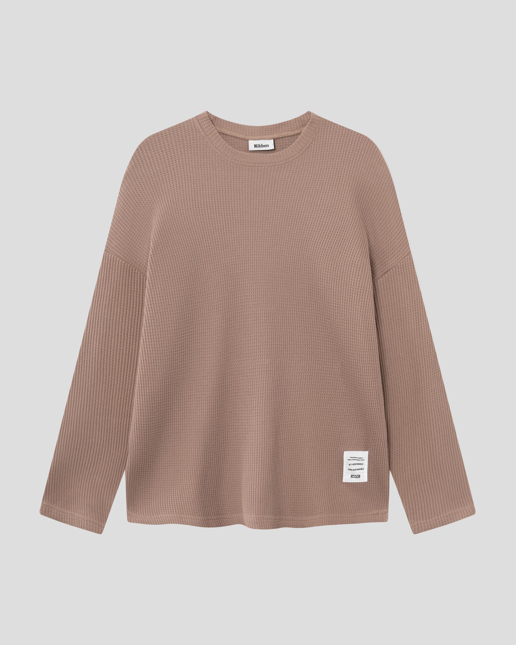 Brown waffle-patterned sweatshirt with a stitched-on material label.