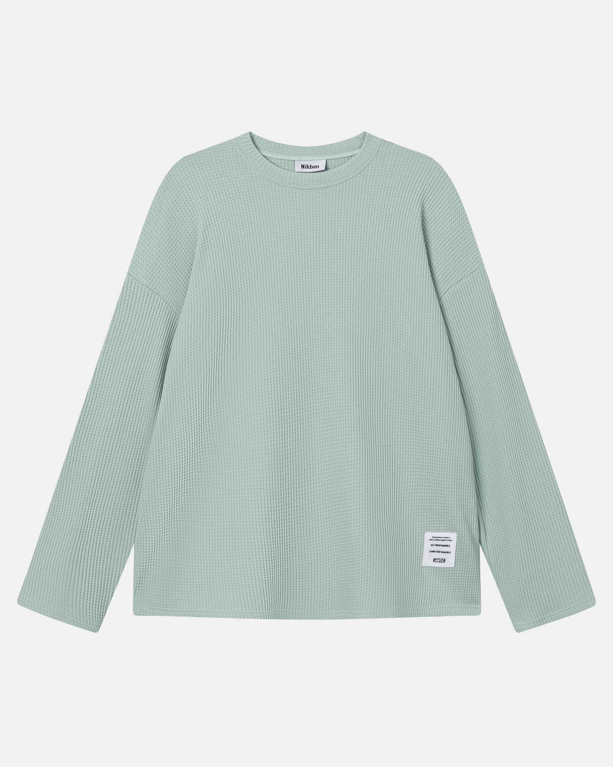 Mint green waffle-patterned sweatshirt with a stitched-on material label.