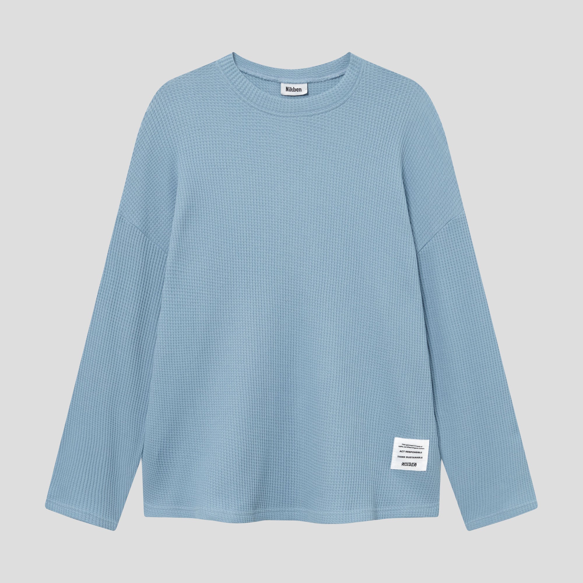 Sky blue waffle-patterned sweatshirt with a stitched-on material label.