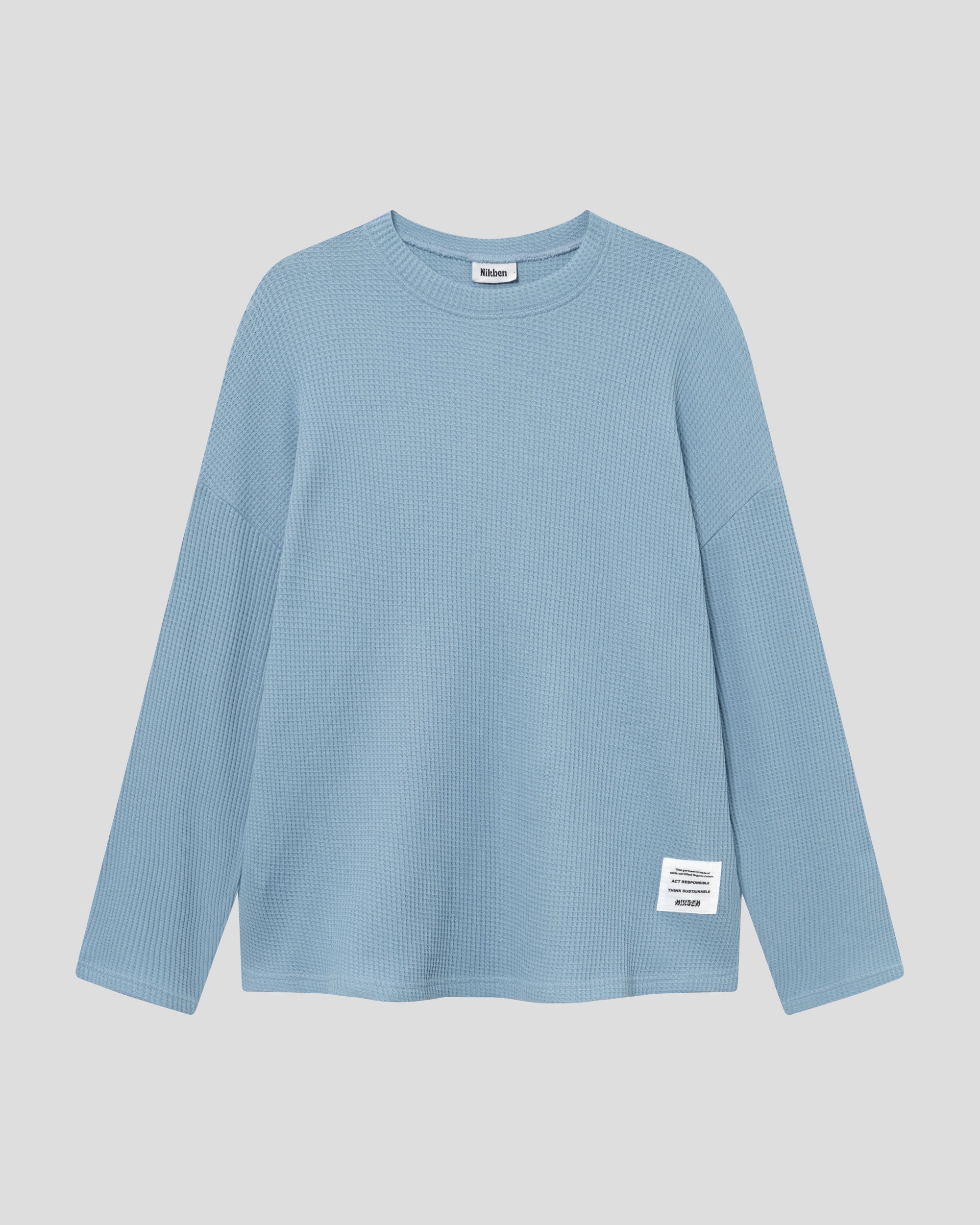 Sky blue waffle-patterned sweatshirt with a stitched-on material label.