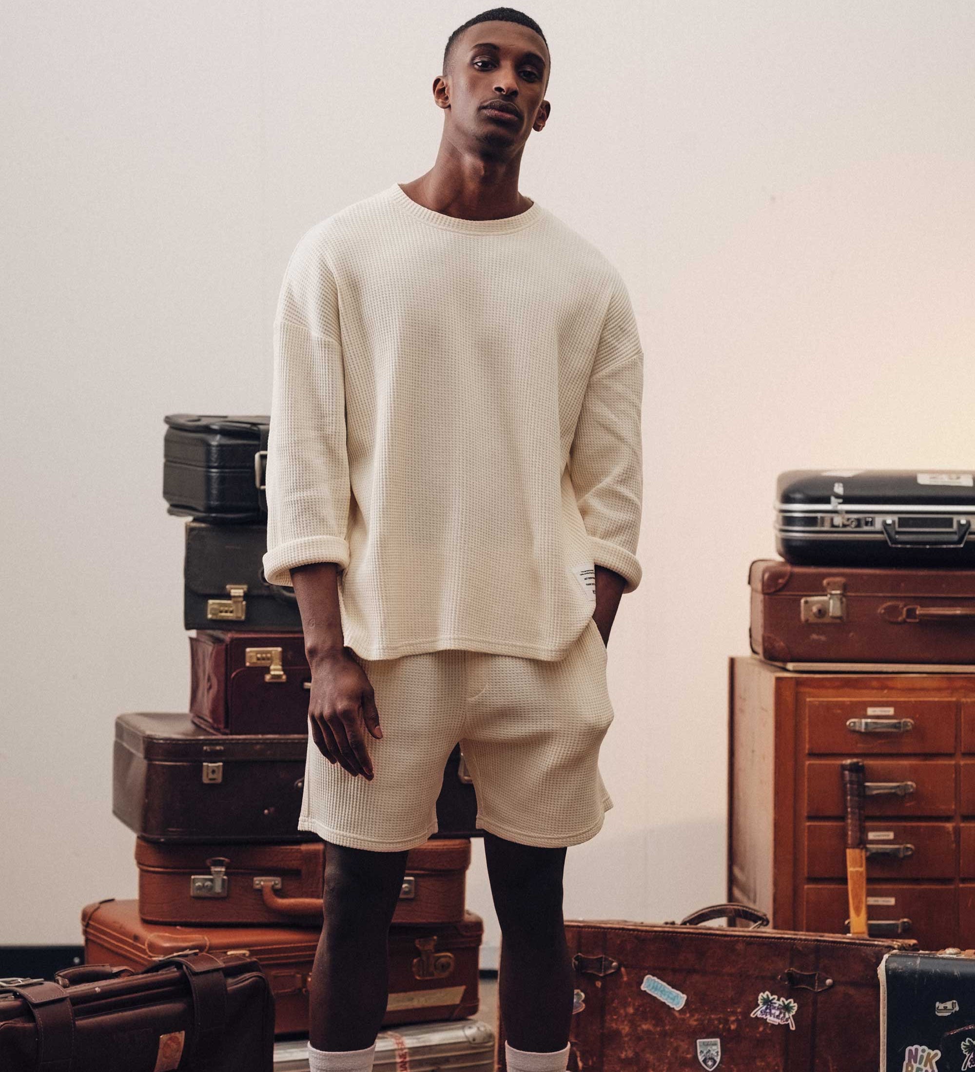 Male model wearing an off-white waffle-patterned sweatshirt with a stitched-on material label.