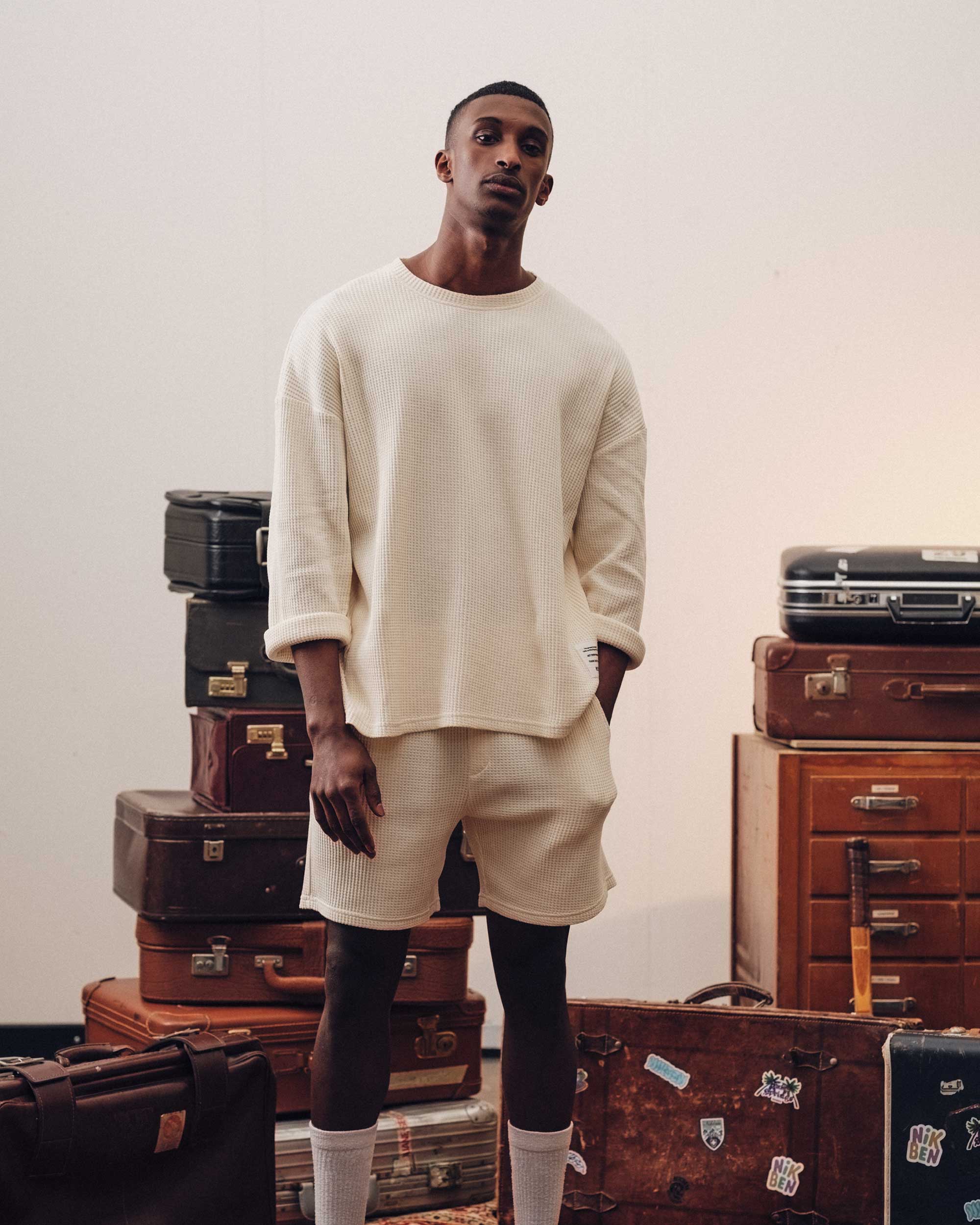 Male model wearing an off-white waffle-patterned sweatshirt with a stitched-on material label.