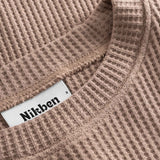 Close up on round neck on a brown waffle-patterned cropped sweatshirt