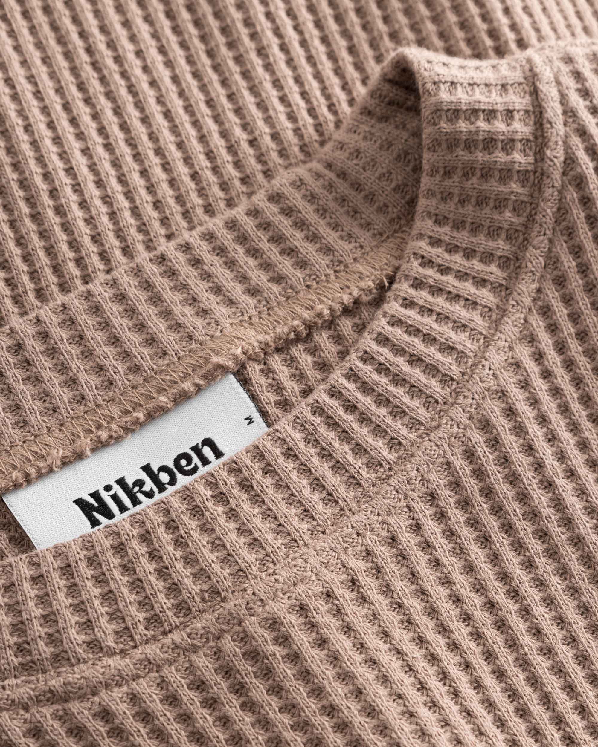 Close up on round neck on a brown waffle-patterned cropped sweatshirt