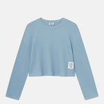 Sky blue waffle-patterned cropped sweatshirt with a stitched-on material label.