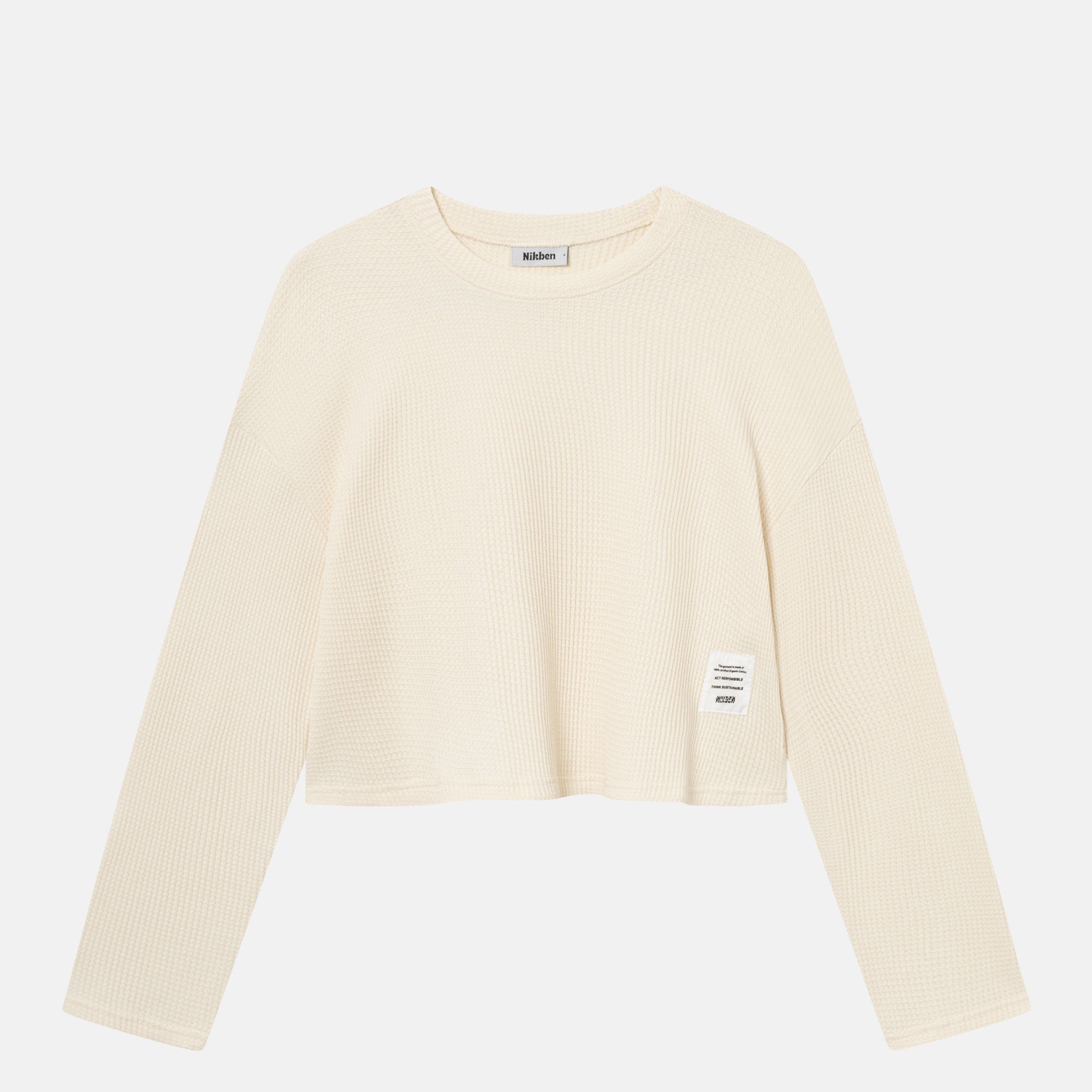 Off-white waffle-patterned cropped sweatshirt with a stitched-on material label.