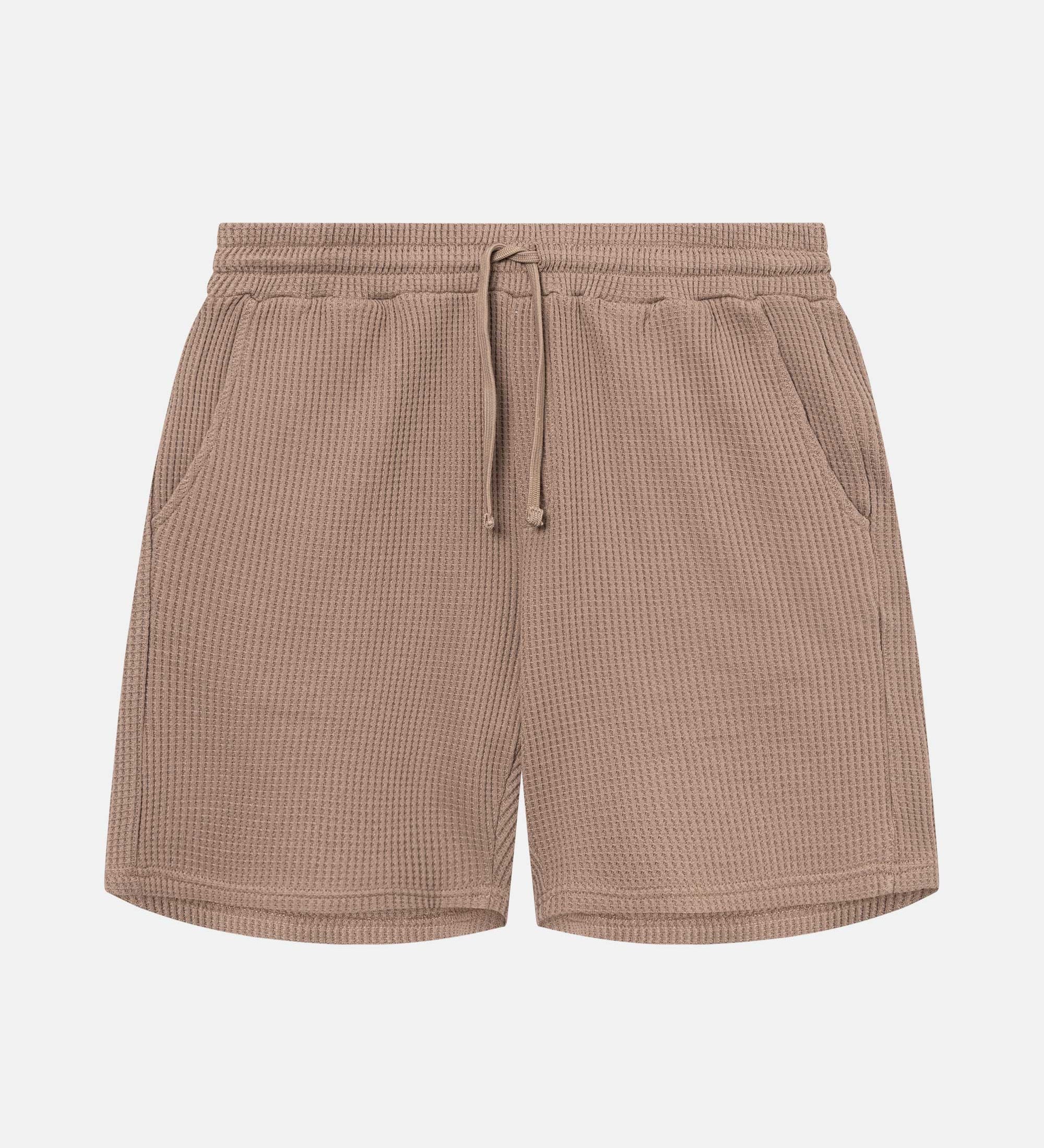 Brown waffle-patterned mid-length shorts with two front pockets and a drawstring.