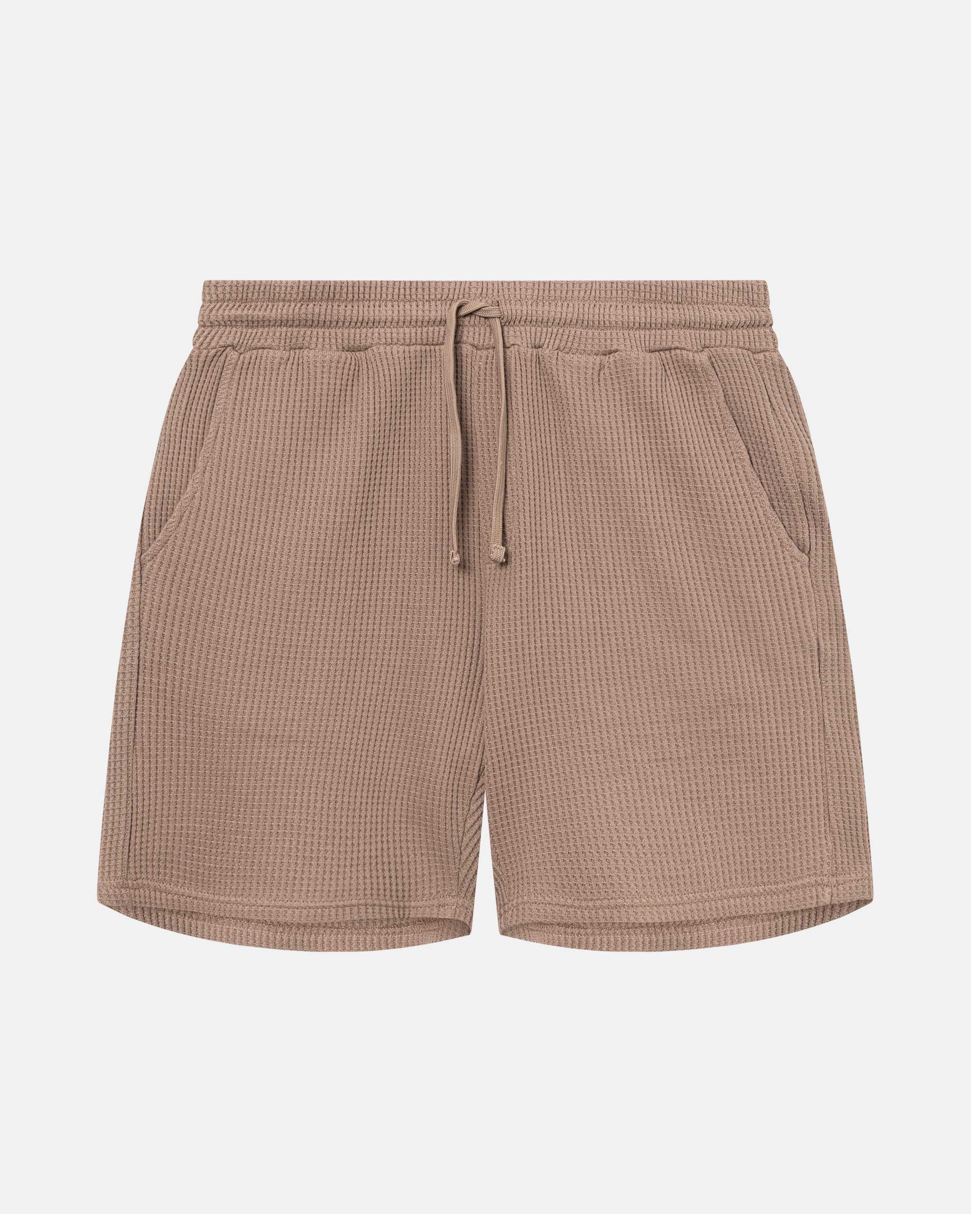 Brown waffle-patterned mid-length shorts with two front pockets and a drawstring.