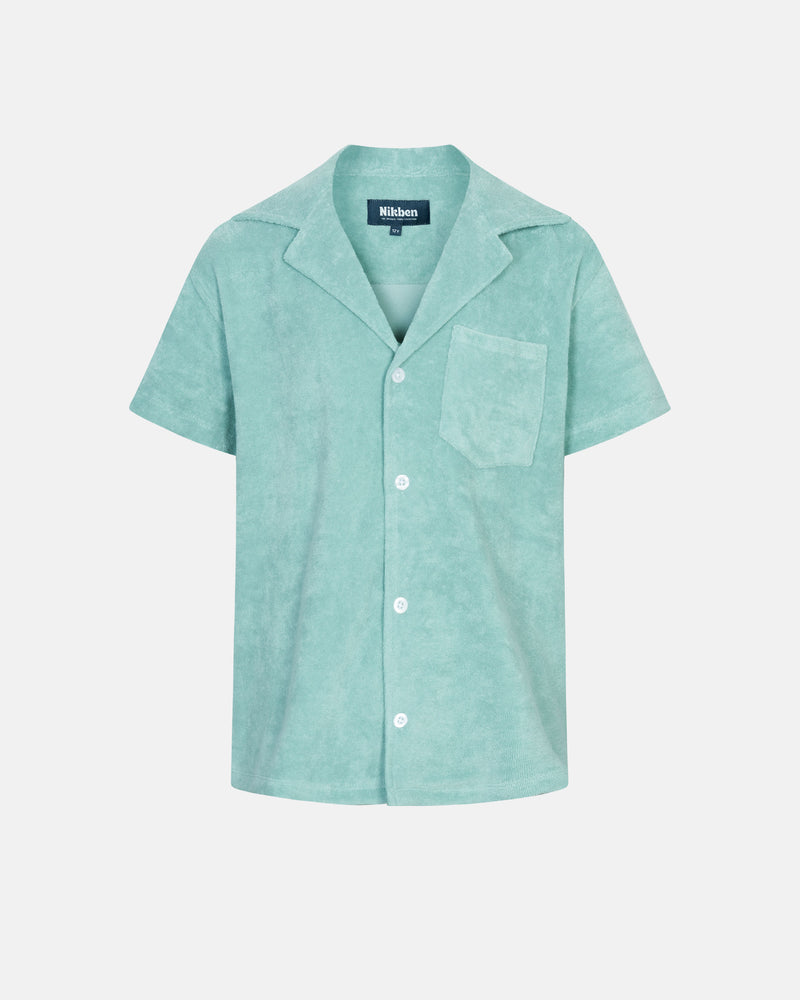Light green short sleeve shirt for kids with white button closure and one chest pocket