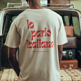Back view of male model wearing cream colored t-shirt with red text print.