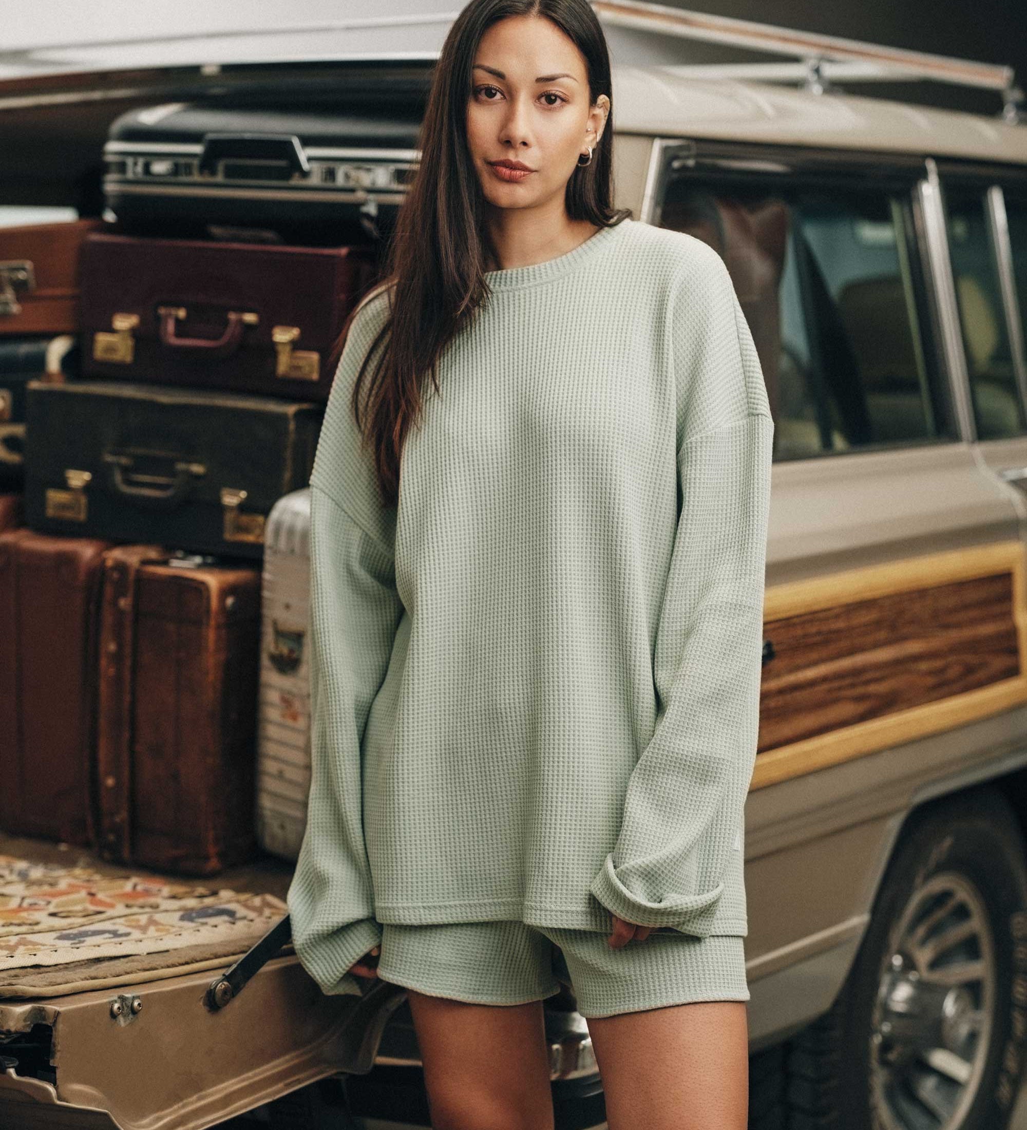 Female model wearing mint green waffle-patterned sweatshirt with a stitched-on material label.