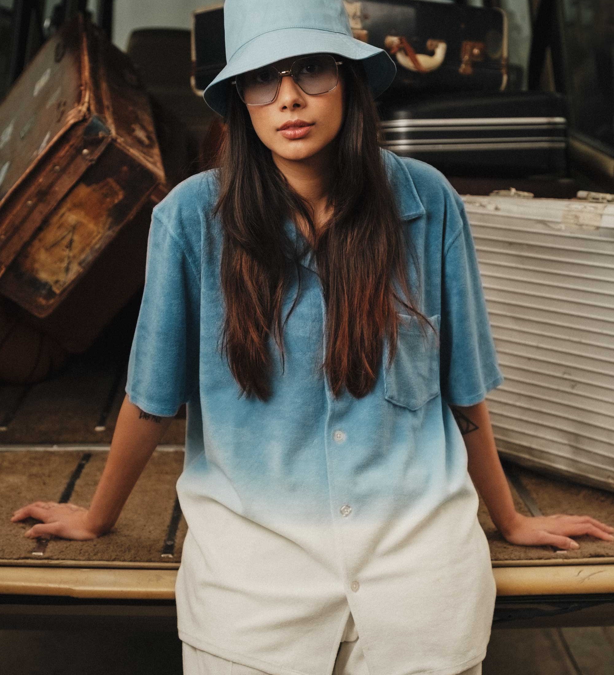 Female women wearing a white and sky blue short sleeve shirt with white button closure and one chest pocket