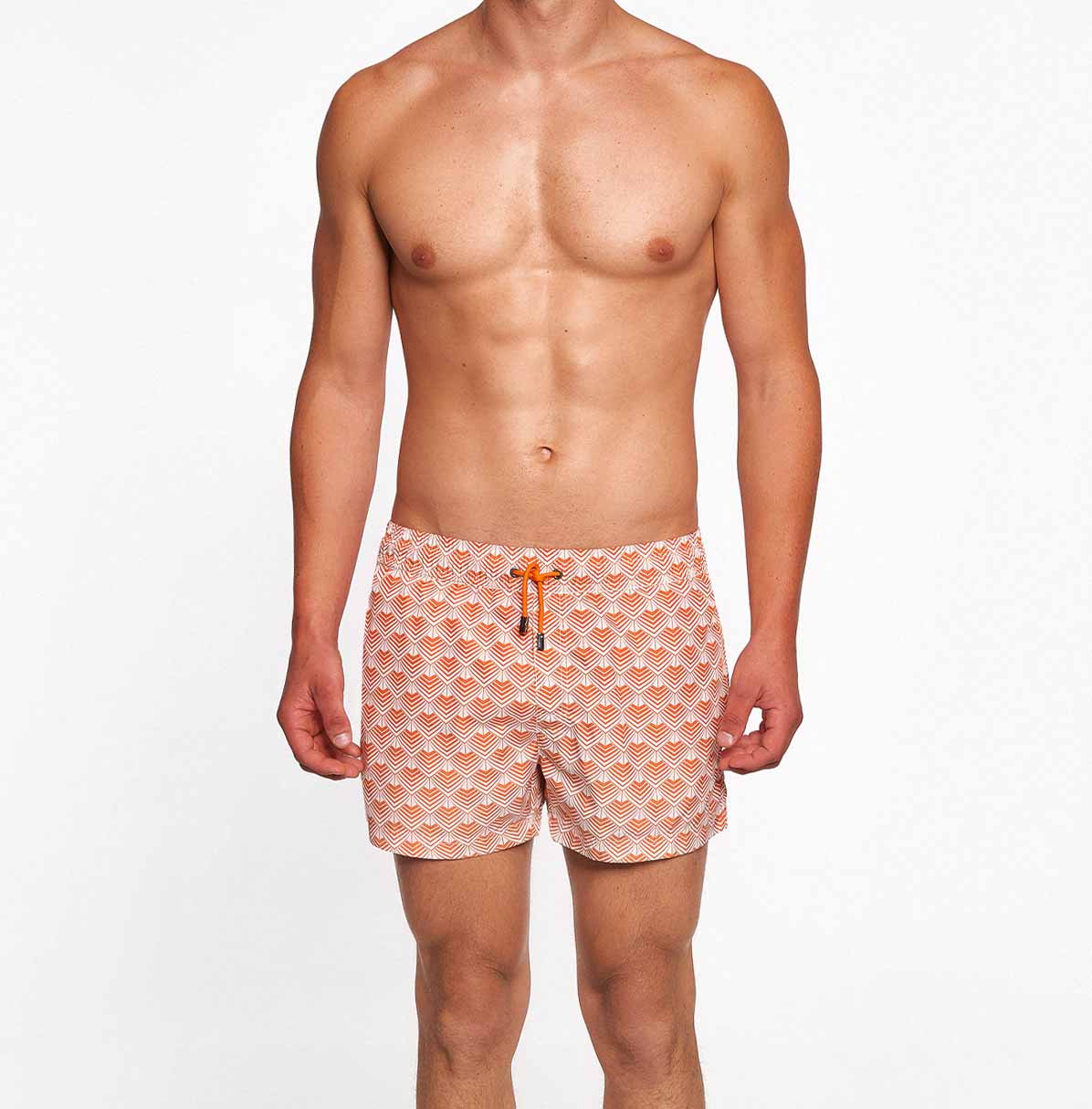Model wearing orange/off white swim trunks
